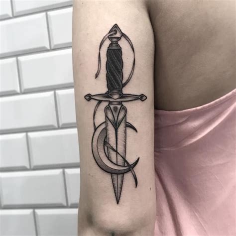 Blackwork Dagger And Crescent Moon Tattoo Inked On The Back Of The Left