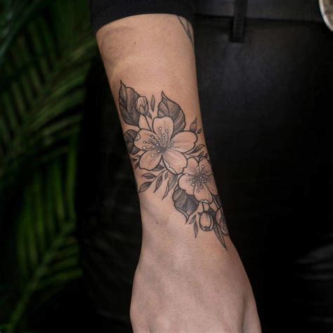 Elegant Flower Wrist Tattoo Ideas For A Delicate Look Wrap Around Elegant Flower Wrist Tattoo Ideas For A Delicate Look Wrap Around