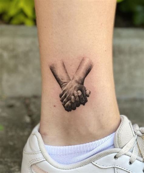 Two Hands Holding Each Other Tattoo